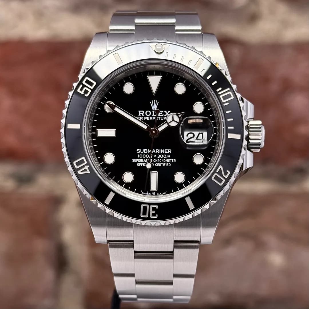 A Submariner Date with a black dial and black ceramic bezel, photographed from the front; the watch carries the serial C1V36Z22